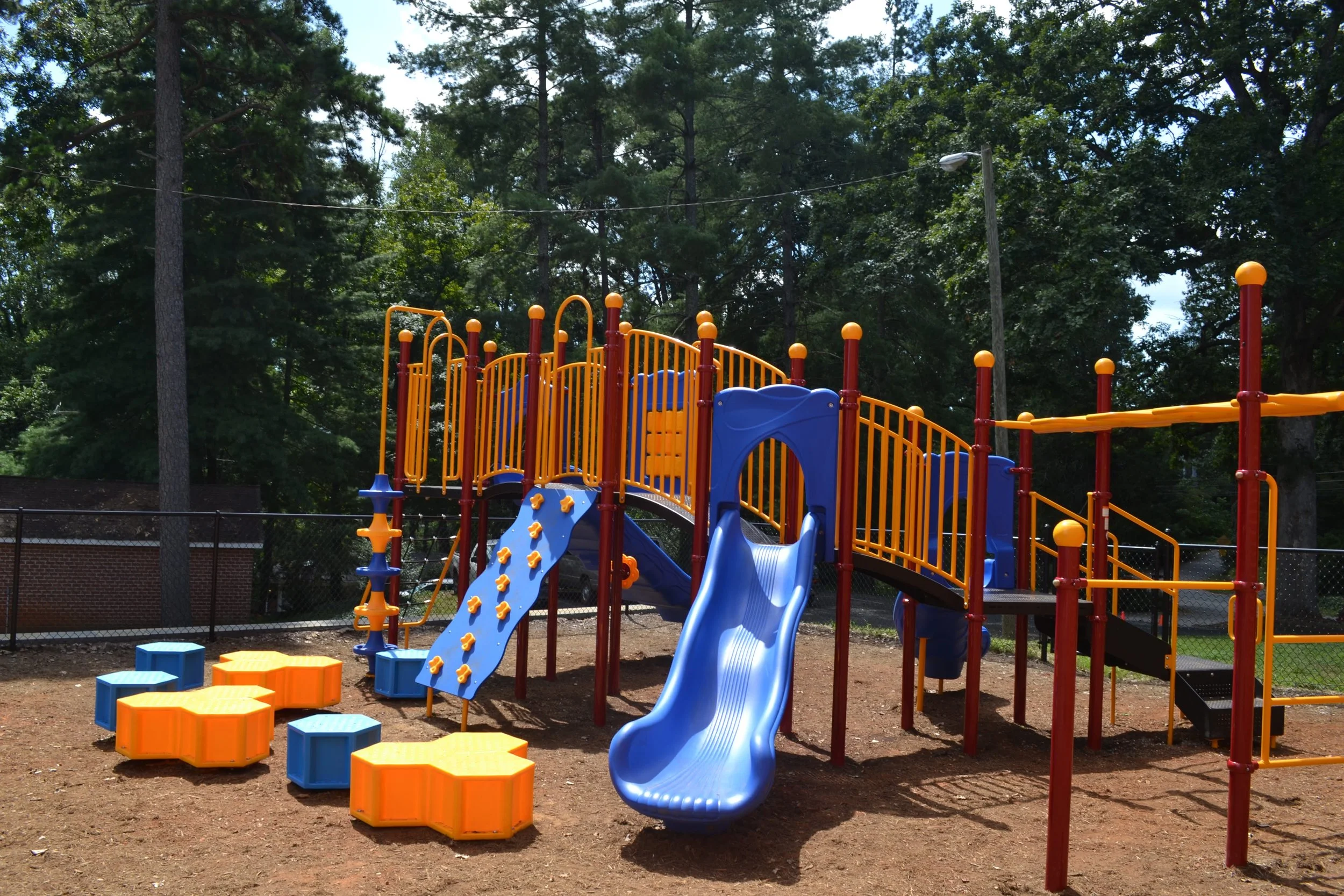 The back of the new playground area inside its fence
