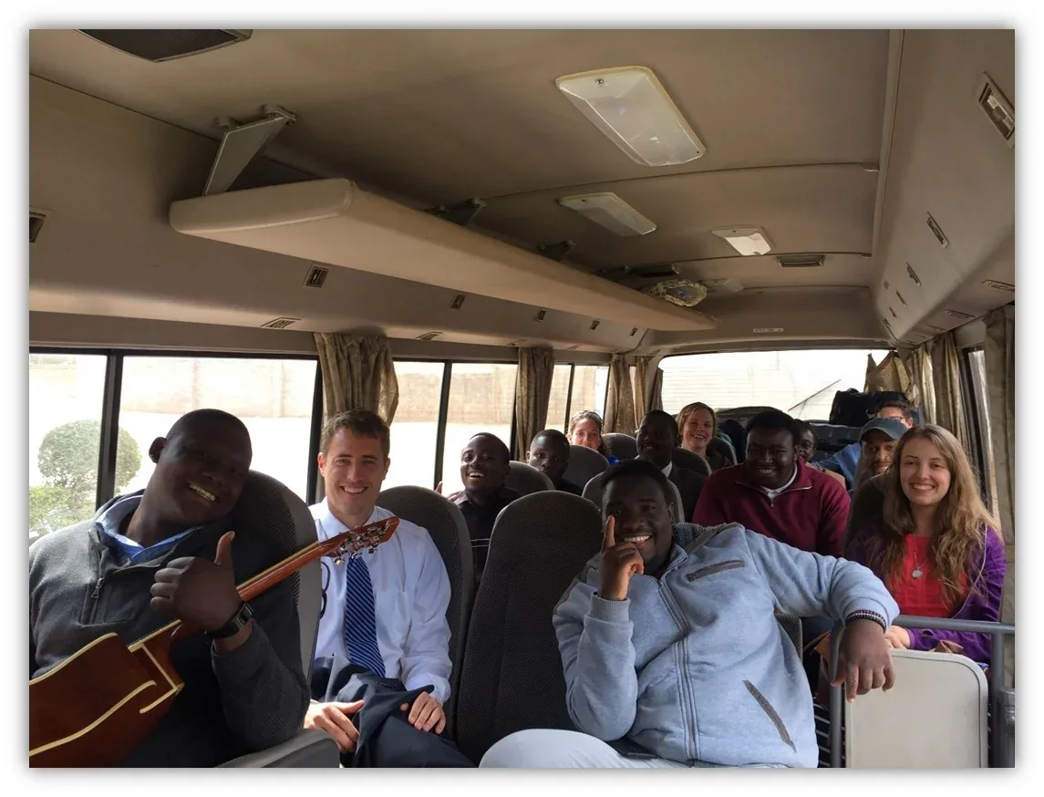 Church members and visitors riding together in a bus on the way to a church service