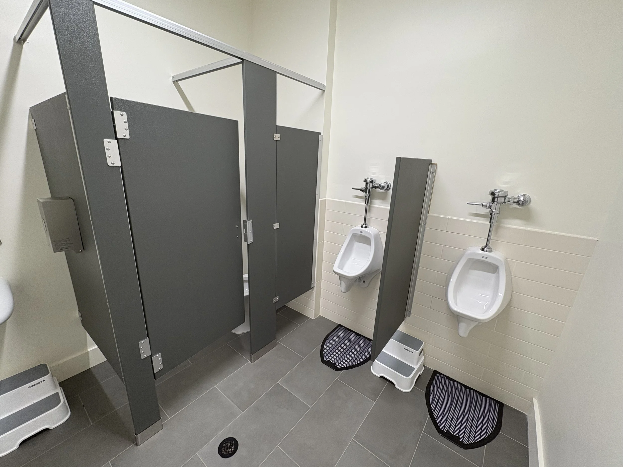 Renovated church bathroom with new partitions, tile, and fixtures