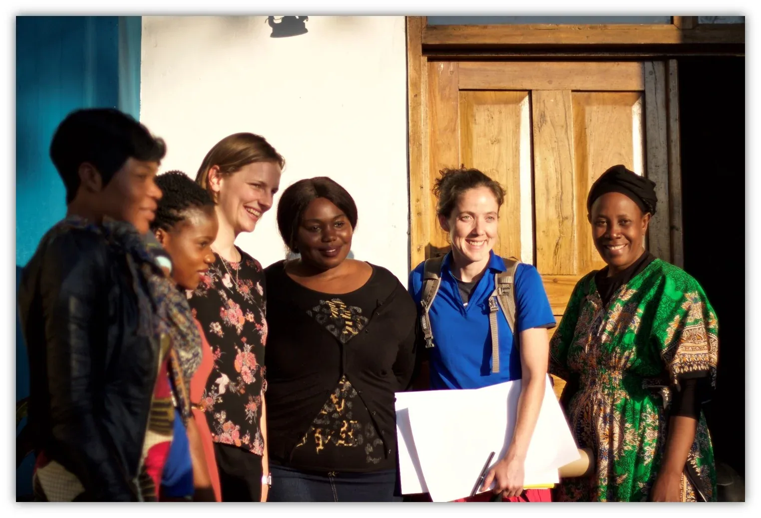 Church members and visitors talking together in a doorway after a service