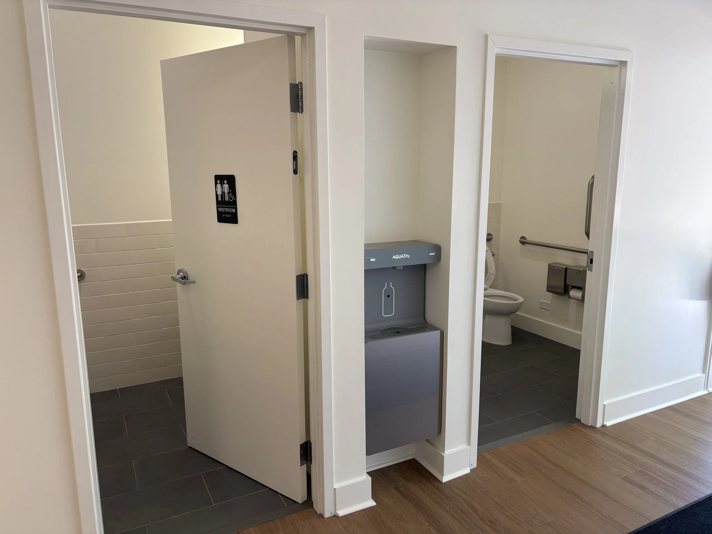 A renovated ADA family bathroom with new fixtures and finishes