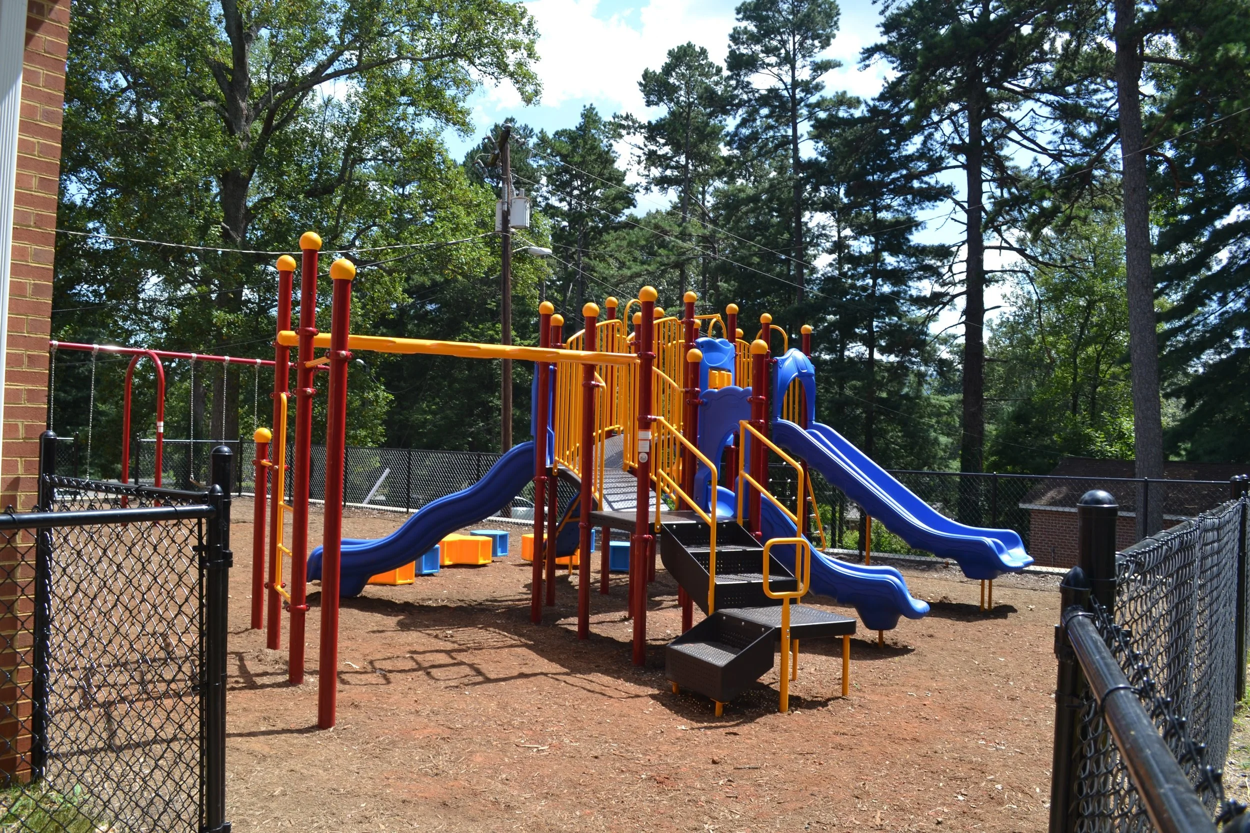 Close view of the new playground structure with slides and climbing bars