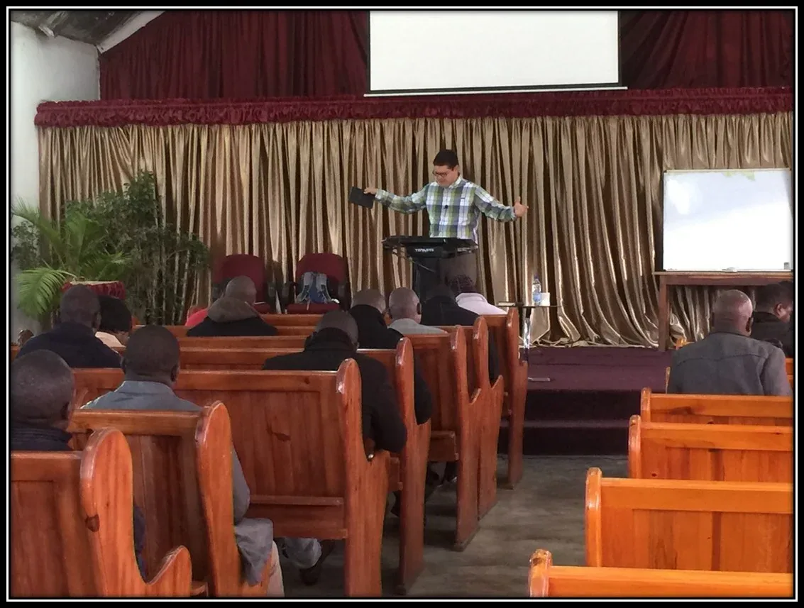 A pastor preaching from the pulpit of Kabwata Baptist Church
